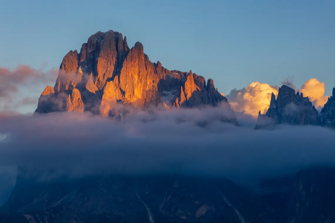 Sunlit Dolomite spires above a sea of clouds