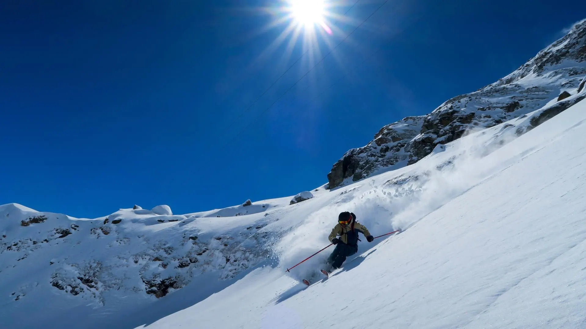Skier descending through fresh snow on Monte Rosa