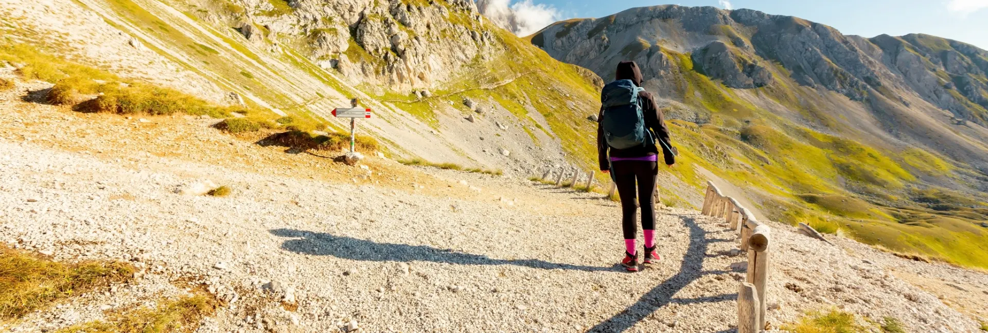 Hiker with a backpack on a mountain trail