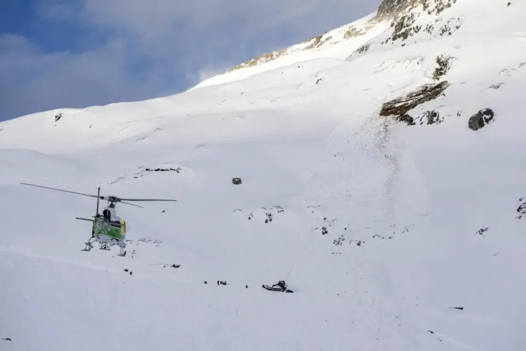 Rescue helicopter landed on a snowy slope